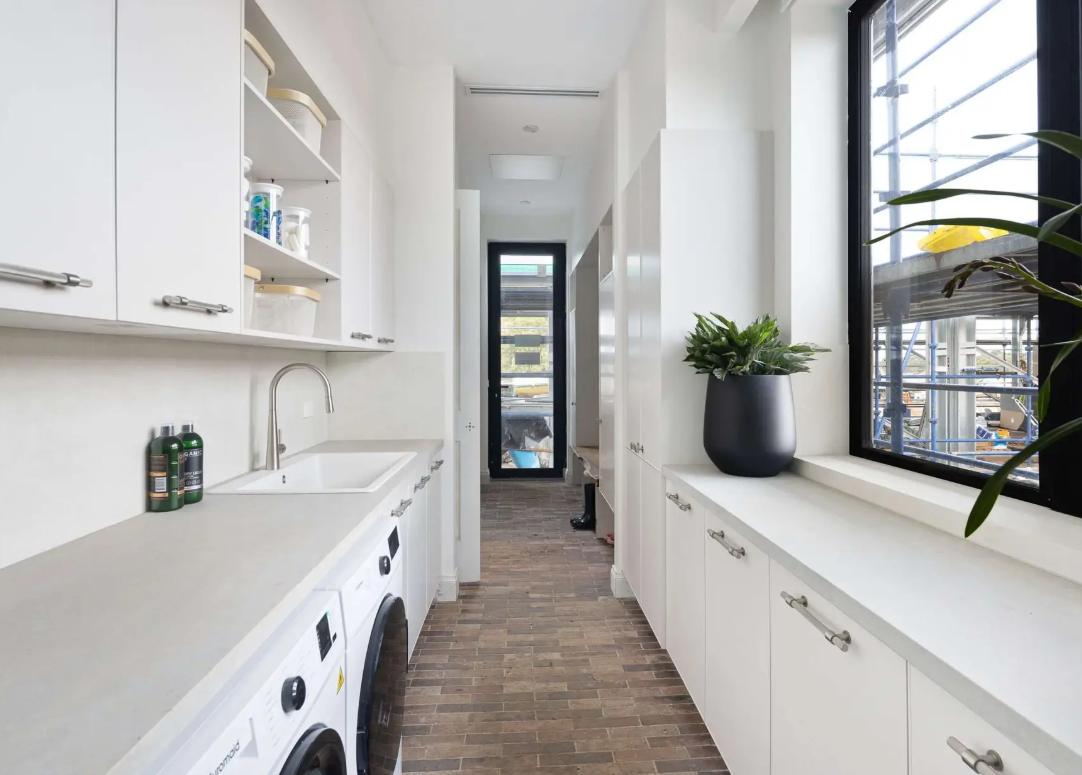 Laundry renovation with integrated cabinetry and storage